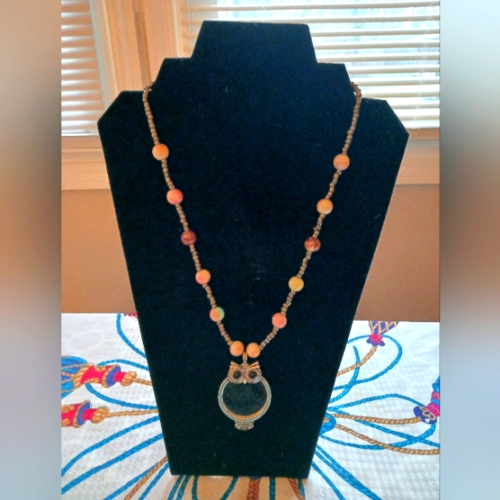 Beaded necklace with owl magnifying glass